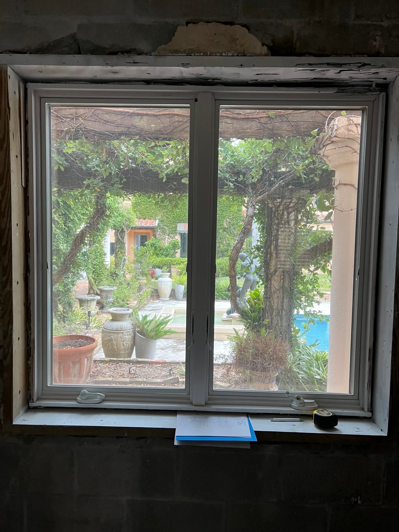During: openings in the masonry, looking out to the courtyard, pergola, and pool