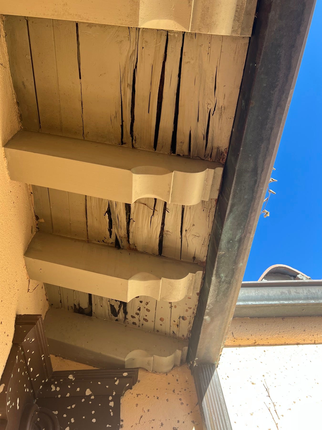 During: failed eave boards and original corbels — the envelope told the truth first