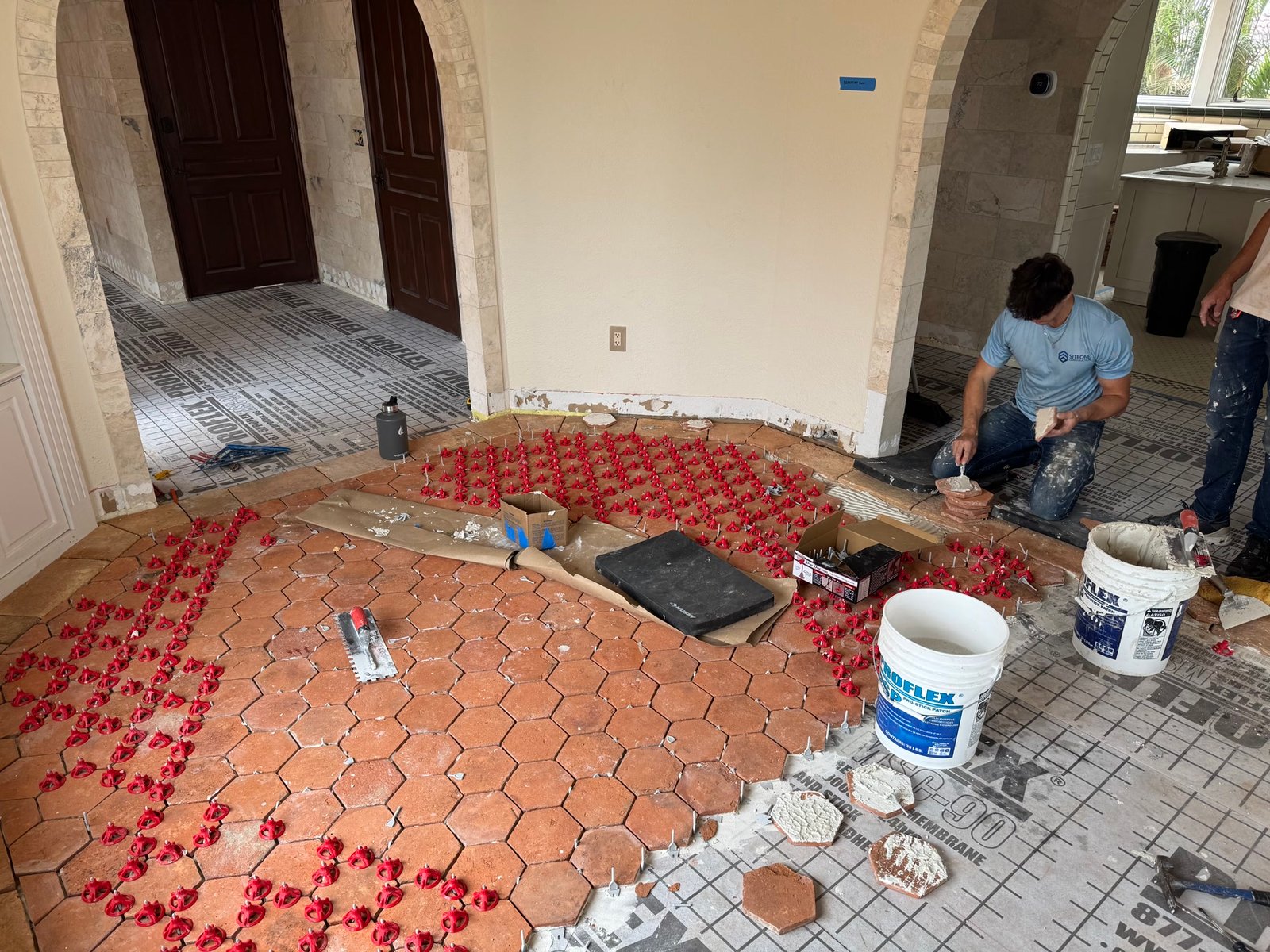 During: hex terracotta going down through the arched rooms