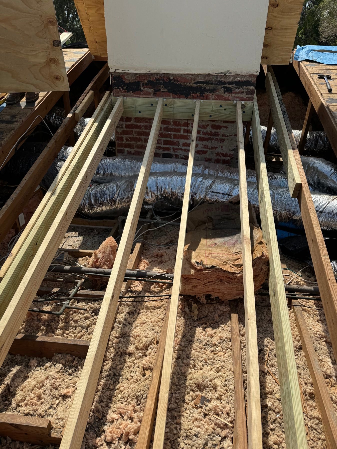 During: new rafters framed into the original brick chimney