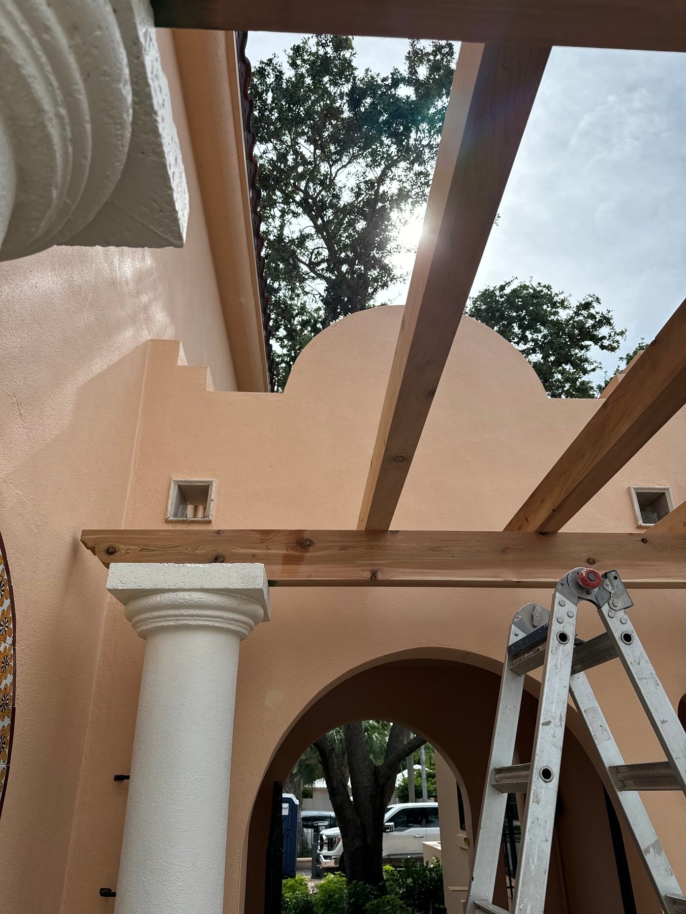 During: new pergola beams set on the original columns and arches