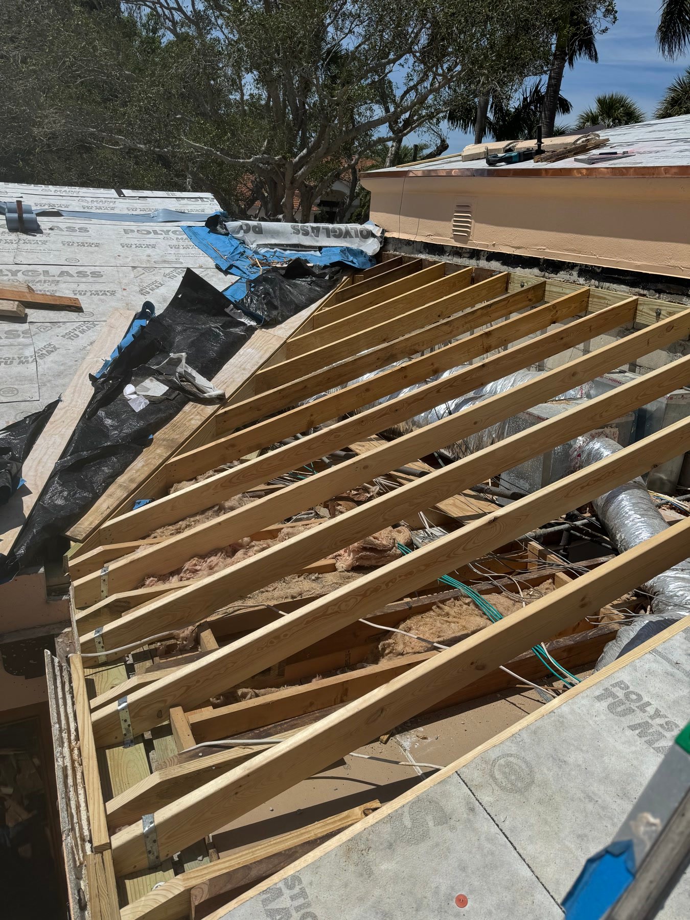 During: new roof framing, underlayment, and copper already on the gutter line