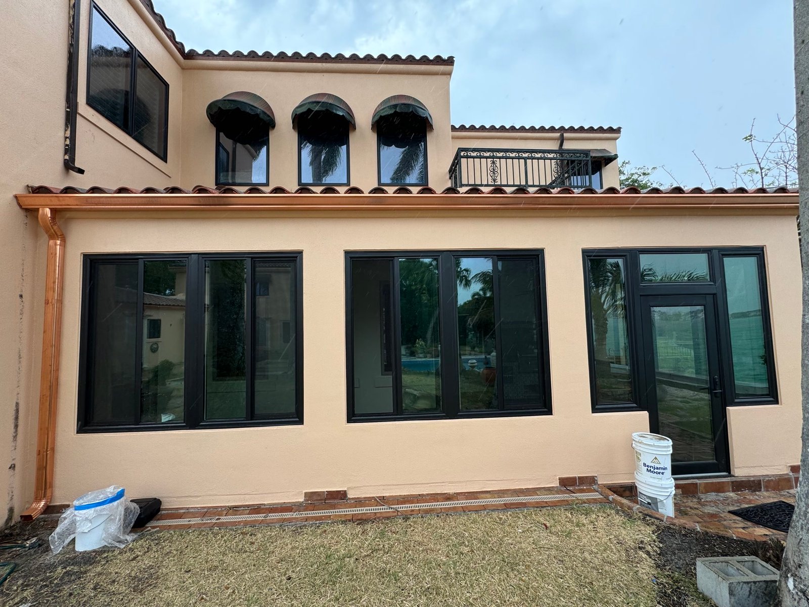 During: new openings and copper gutters on the restored stucco