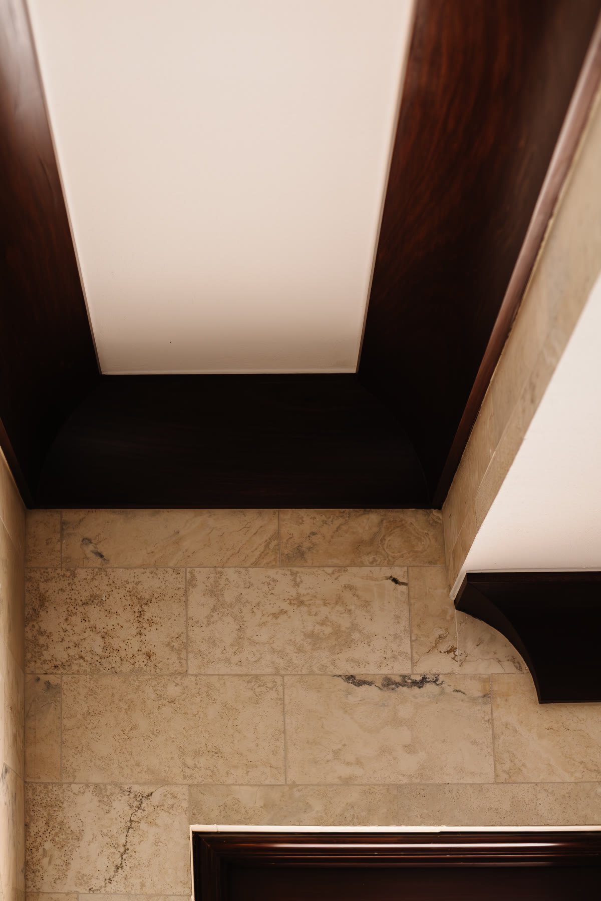 Stone threshold and dark wood arch — the joint between rooms in a restored Mediterranean house