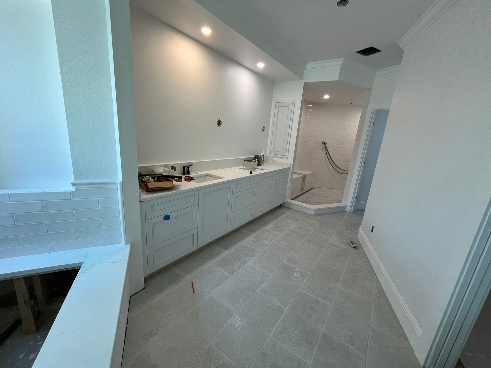 During: new primary vanity and shower as the suite comes back together