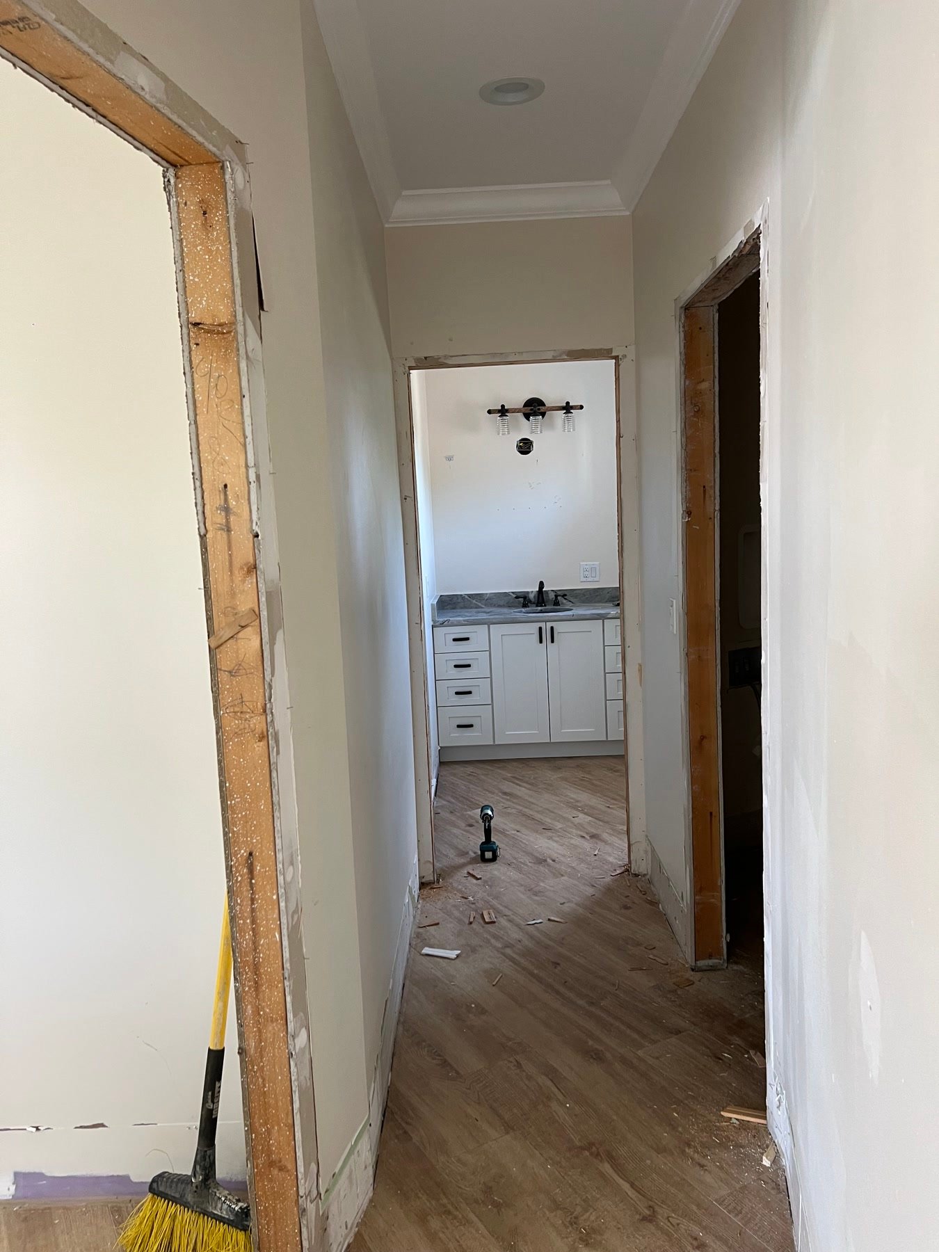 During: foyer and laundry hall after the suite was replanned — new floors, millwork going in