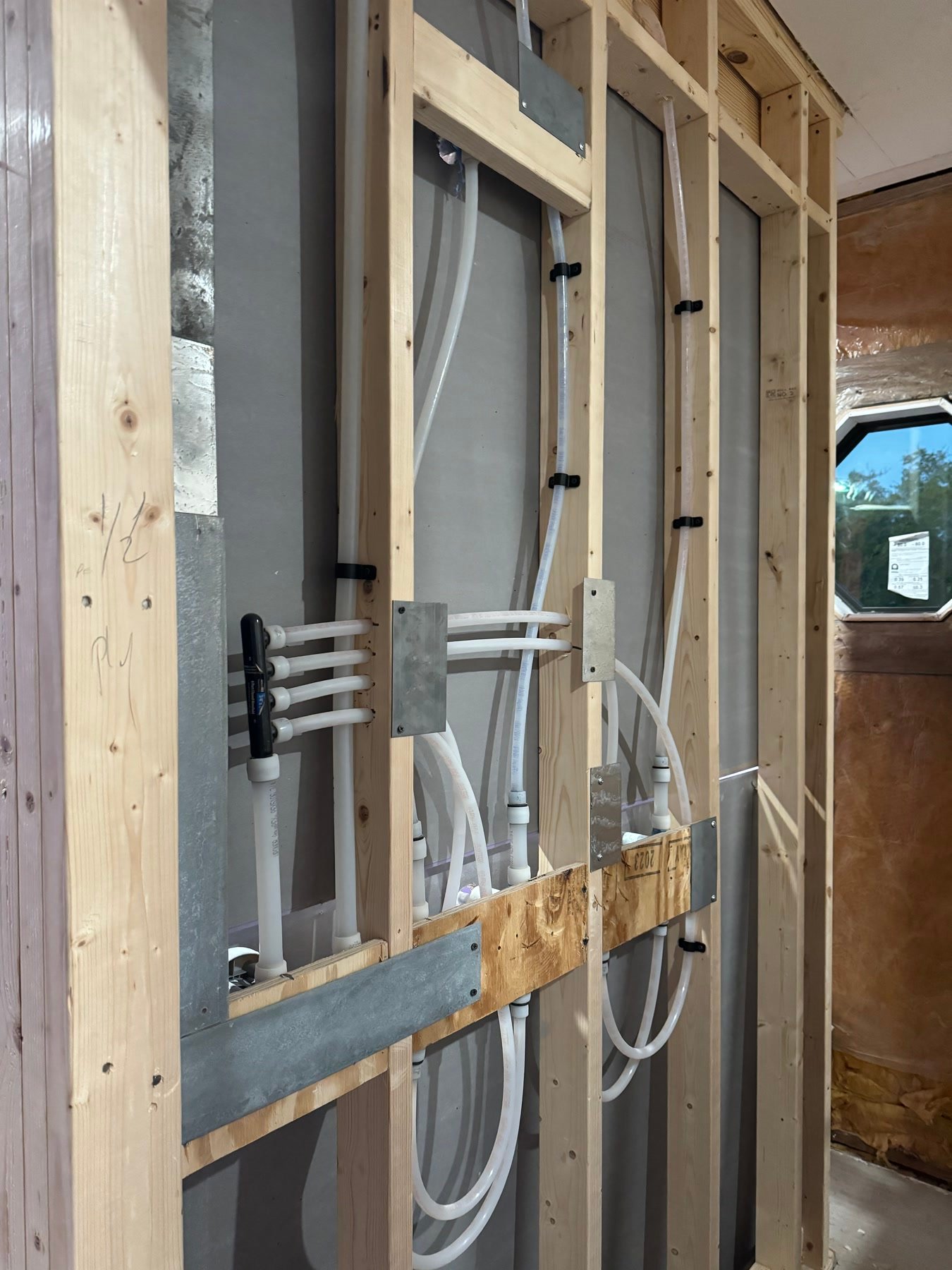 During: PEX and blocking in the rebuilt wet wall before drywall