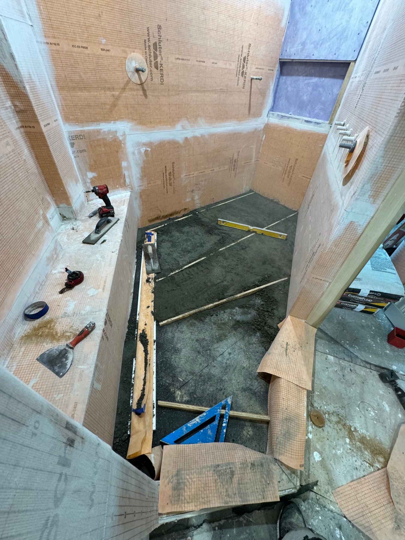 During: mortar bed in the enlarged primary shower, Kerdi on the walls
