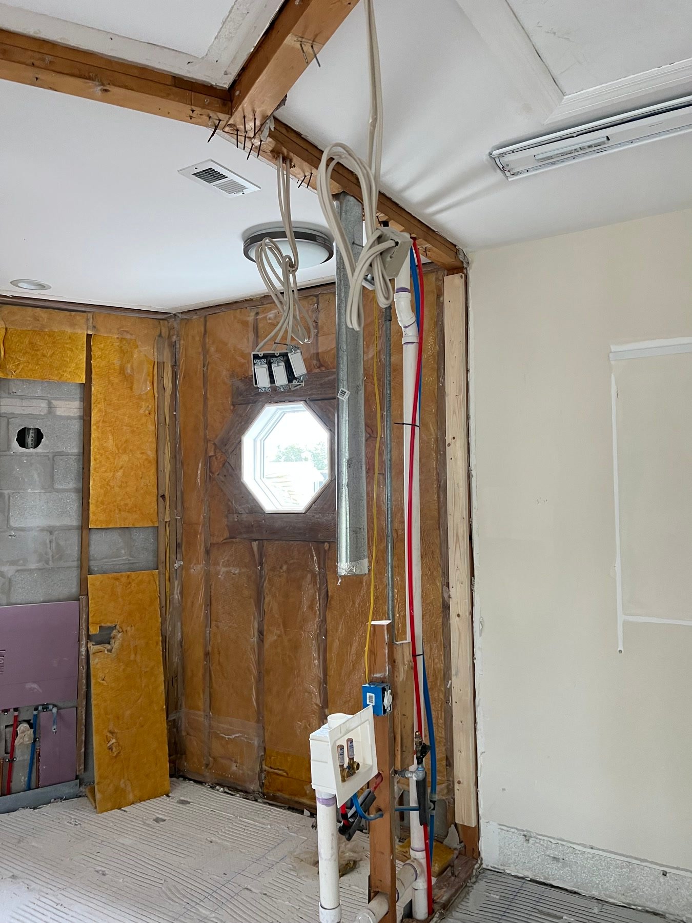 During: suite walls opened to the octagon window, insulation, and new plumbing in the wet wall