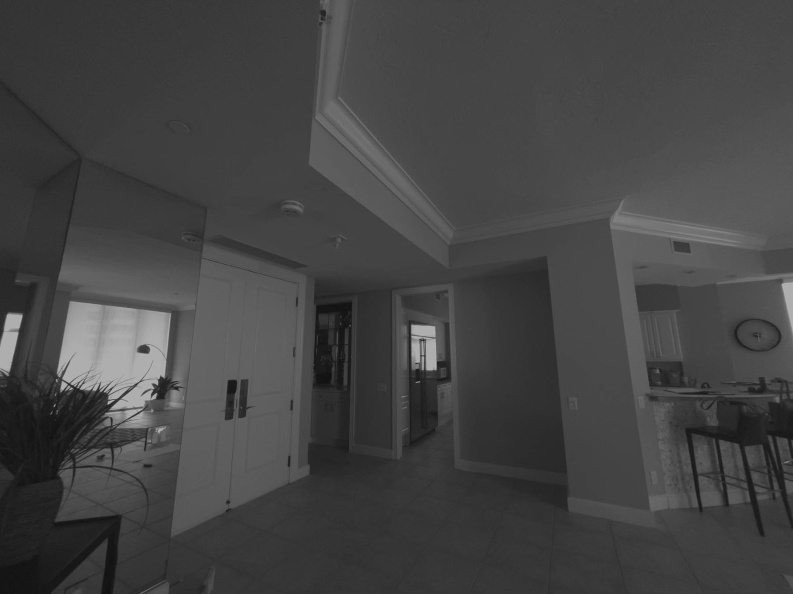Before: entry looking through to the old kitchen — textured ceiling, beige tile, no interior overhang