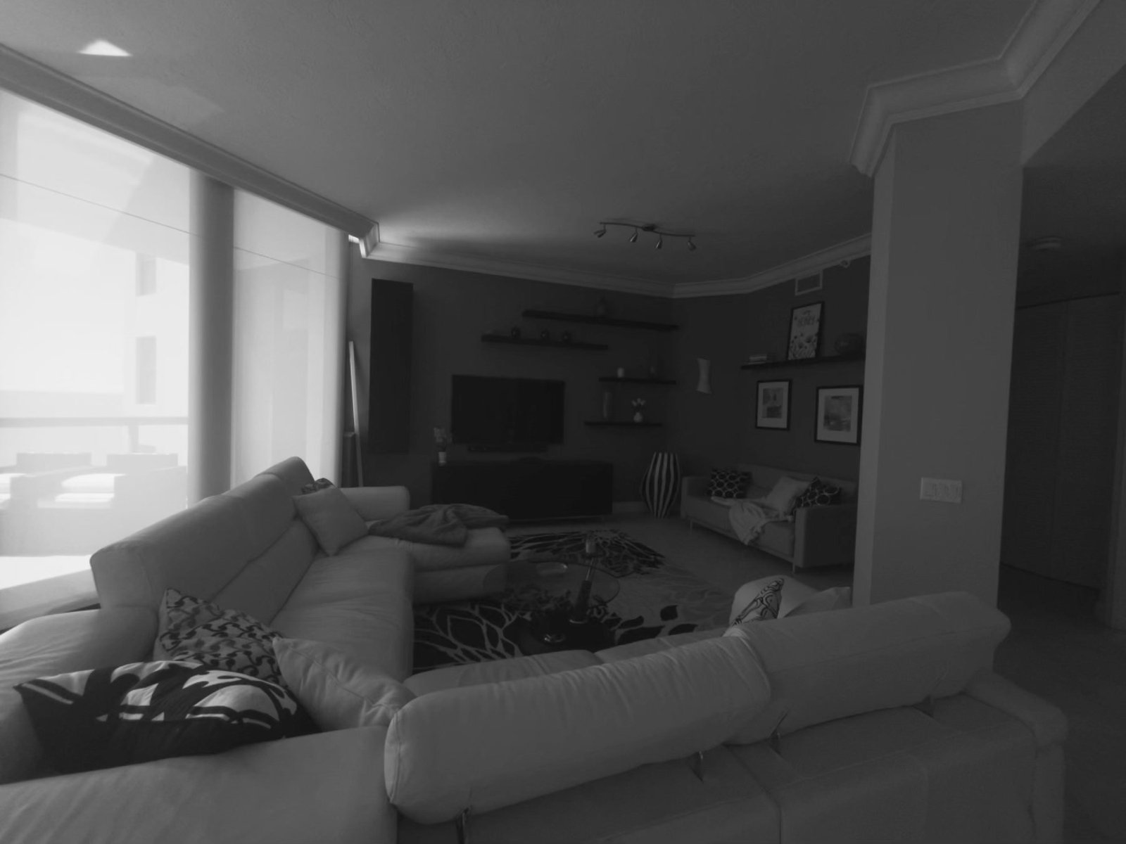 Before: living room with an olive accent wall, beige tile, and leftover volume that did not earn its space